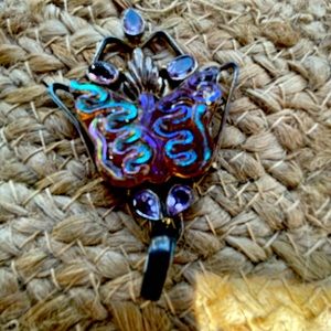 Handcrafted rainbow quartz butterfly pendant set in high fired copper.
